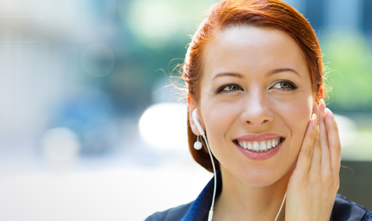 Photo of woman listening to navigation audio