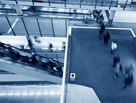 A picture of many people moving through an office building